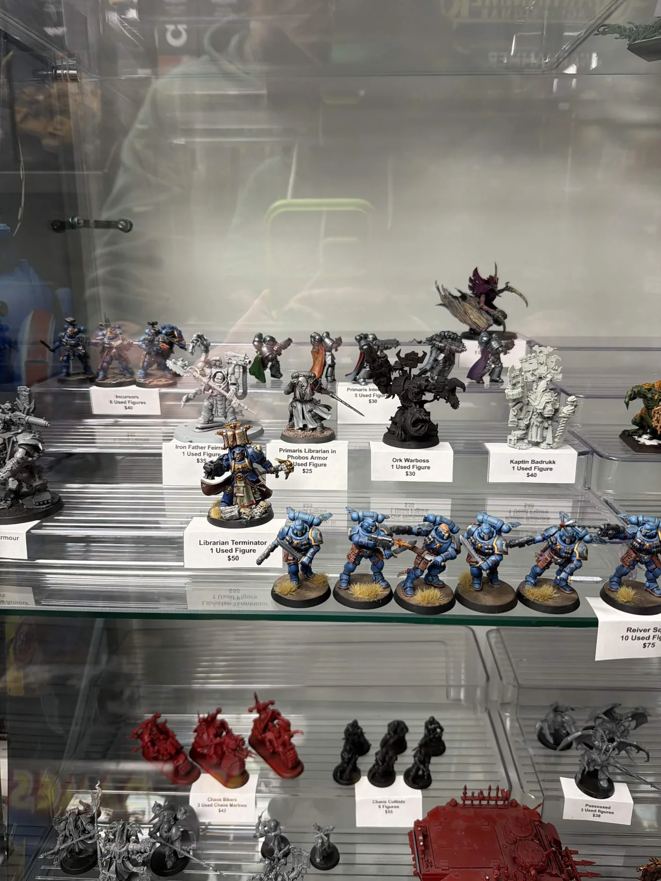 Painted Warhammer miniatures on display in the cabinet