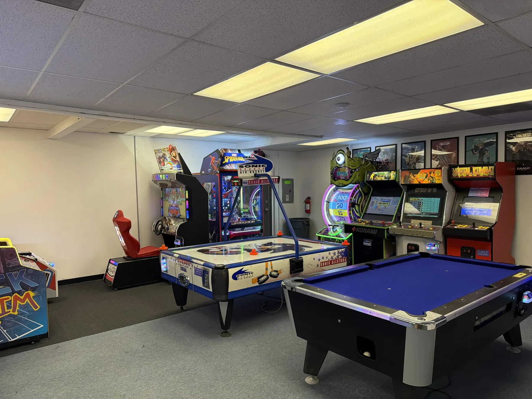 The arcade and games room with a pool table, air hockey, and classic arcade cabinets